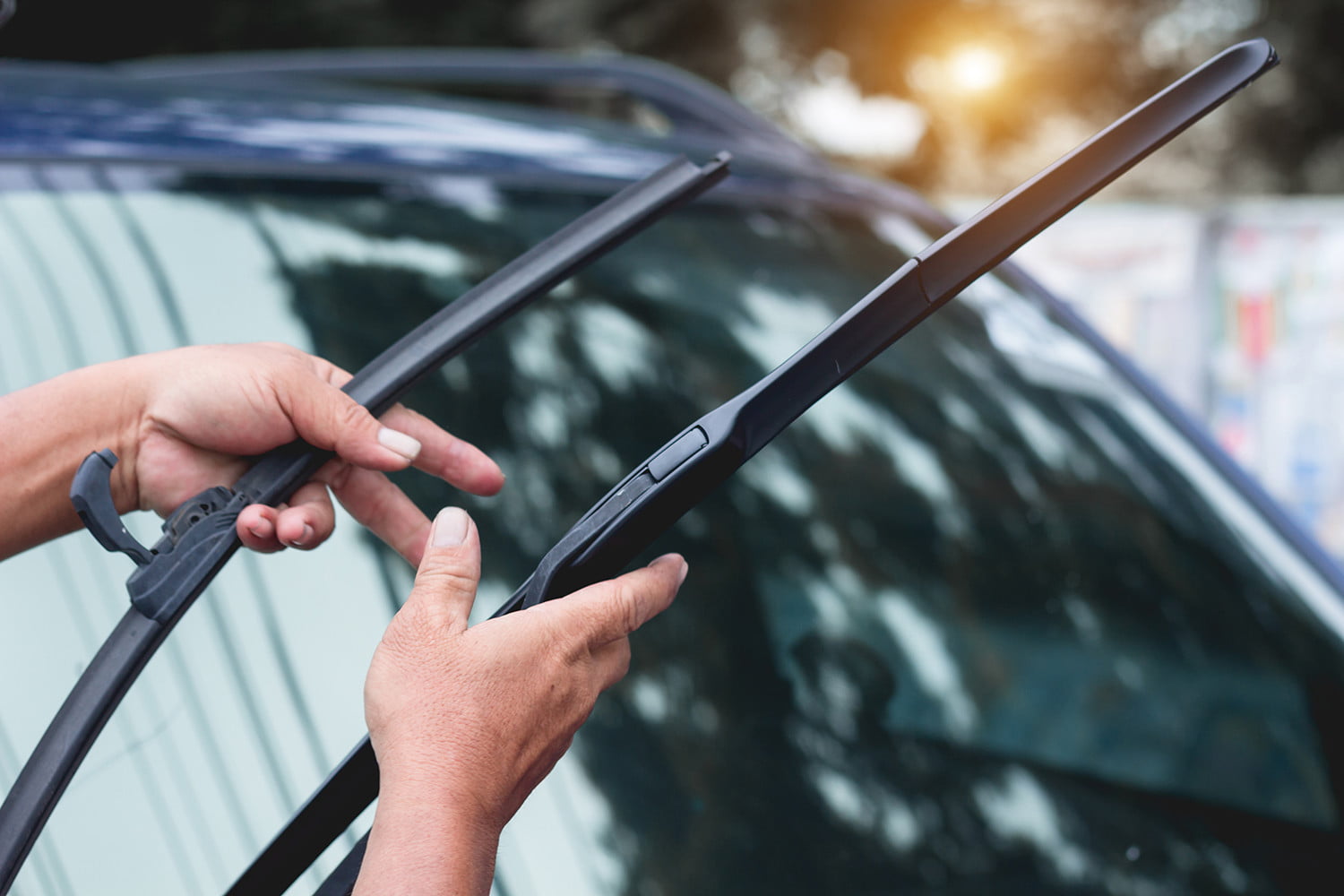 cropped-hands-holding-windshield-wiper